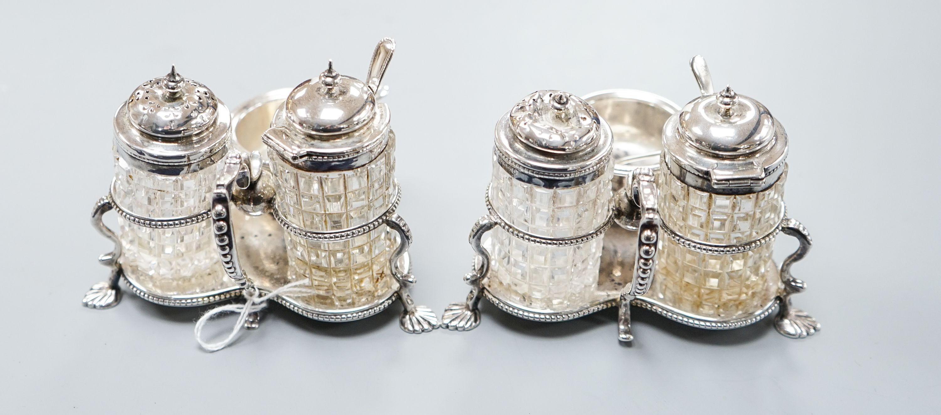 A pair of Victorian silver cruet stands, each with three cruets, Jane Brownett, London, 1880, height 85mm.